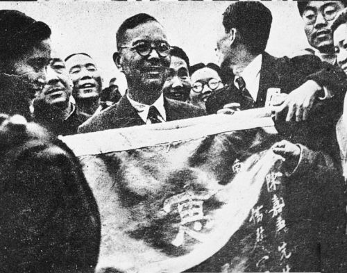 1940年3月，陈嘉庚率领“南洋华侨回国慰劳视察团”回国慰劳抗战军民，于12月31日返回新加坡，历时十月余，遍历西北、西南各省，慰劳抗日将士，呼吁团结抗战，赢得了广大同胞的尊敬和钦佩。图为慰劳团抵渝时，旅渝厦大、集美校友向陈嘉庚献旗